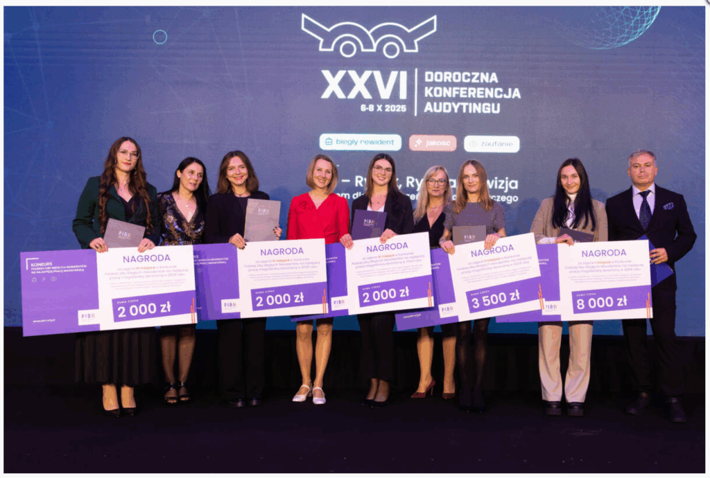 Na zdjęciu przedstawiona jest grupa ośmiu osób stojących w rzędzie. Są to kobiety i mężczyzna, wszyscy elegancko ubrani. W tle widać ciemne tło z logo i napisem "Doroczna Konferencja Audytingu", co sugeruje, że to wydarzenie związane z audytem. Wszyscy trzymają duże tablice z napisem "Nagroda" i kwotami od 2000 zł do 8000 zł, co wskazuje, że są to uczestnicy lub laureaci konkursu związany z audytem. Panuje atmosfera radości i triumfu, sugerująca, że osoby te są zadowolone z otrzymanych nagród. Miejsce wygląda jak scena konferencyjna. Czas dnia czy sezon nie jest możliwy do ustalenia na podstawie samego zdjęcia.